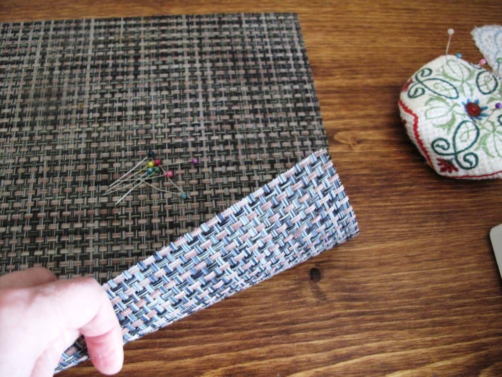 Take a plastic lunch mat and pin your embroidery item carefully.