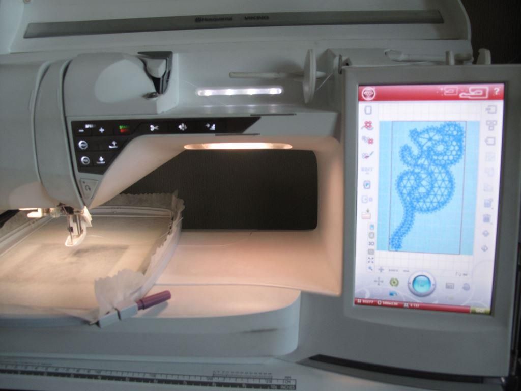 The embroidery hoop securely attached to the machine.